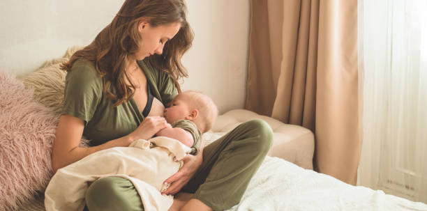 The concept of breastfeeding. Portrait of mom and breastfeeding baby.